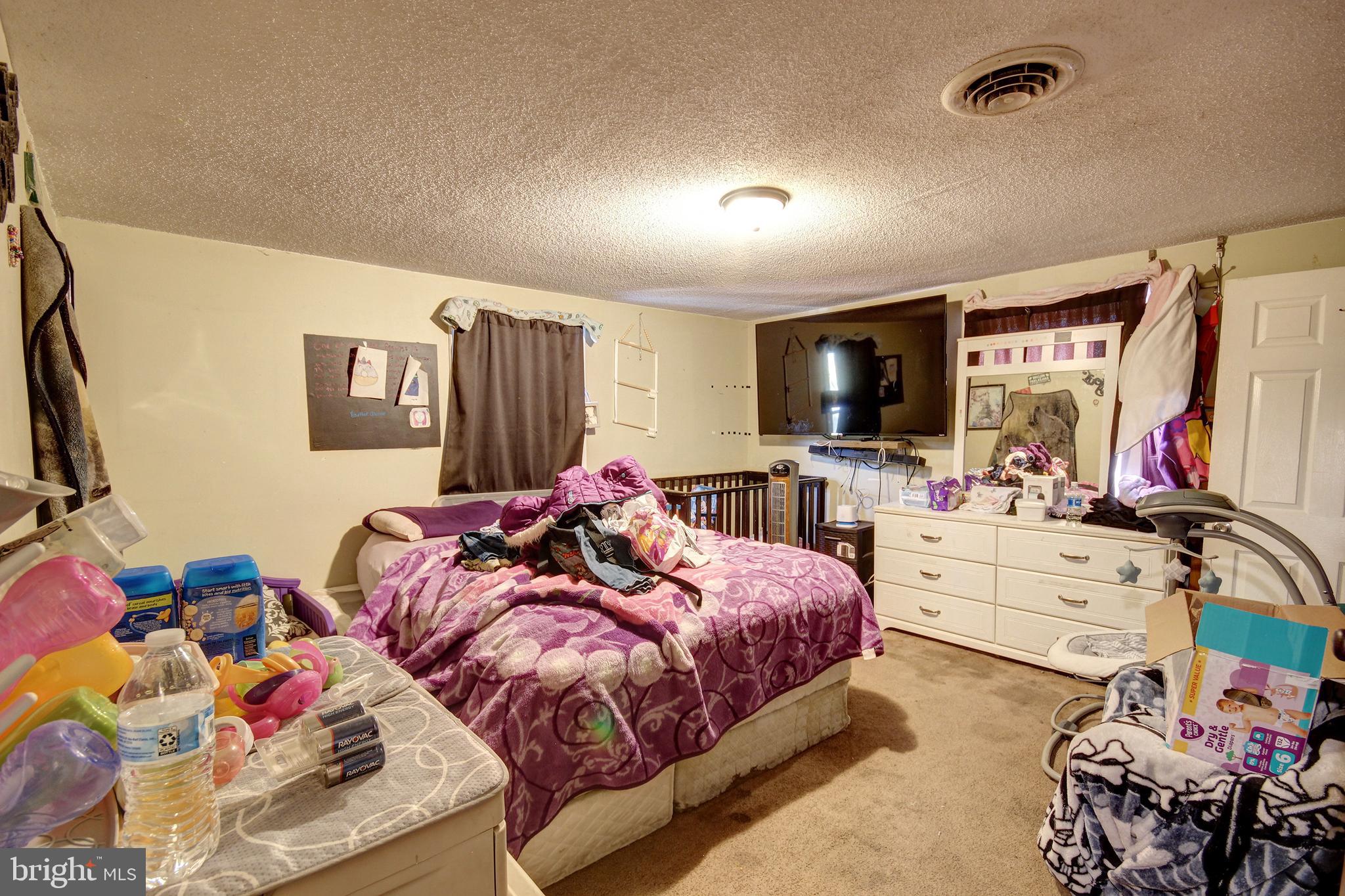 11 West Chestnut Street Delmar, MD 21875 - Photo 10 of 14 a bed room with bed and a flat screen tv