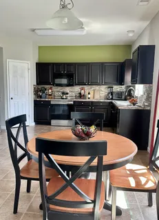a kitchen with a table and chairs in it