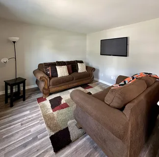 a living room with furniture and a flat screen tv