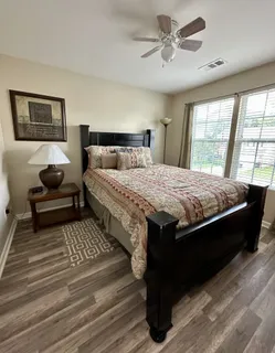 a bedroom with a bed and wooden floor