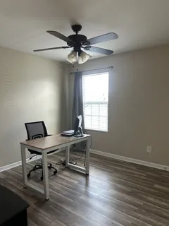 a view of a workspace with furniture window and wooden floor