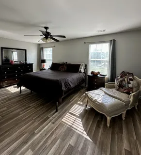 a bedroom with bed and a chandelier