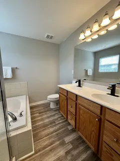 a bathroom with a double vanity sink and a mirror