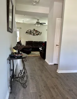 a living room with furniture and wooden floor