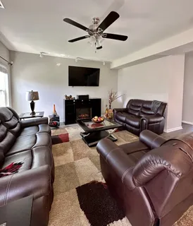 a living room with furniture and a flat screen tv
