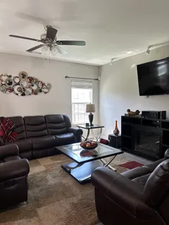 a living room with furniture and a flat screen tv
