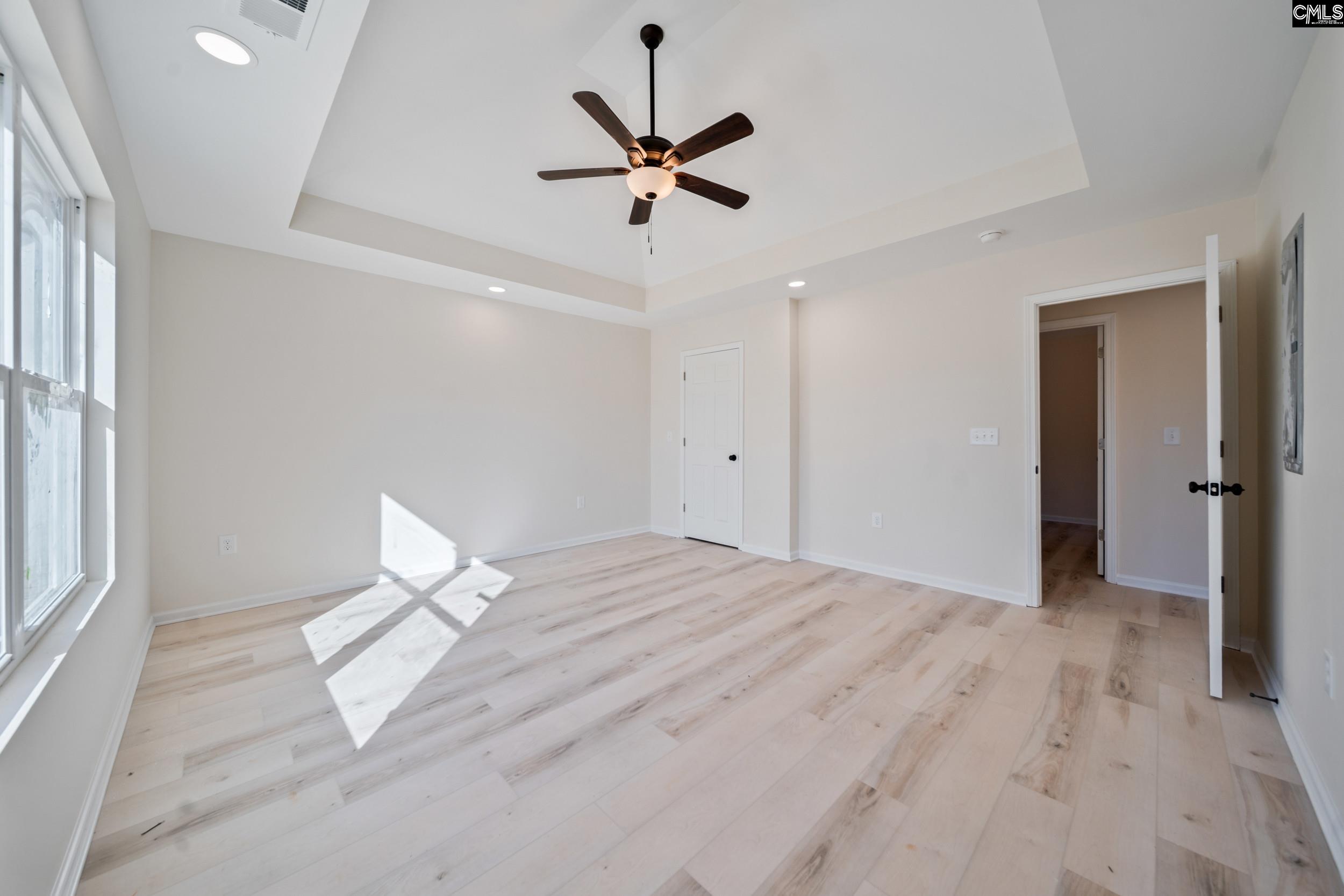 116 Sunny Acres Road Eastover, SC 29044 - Photo 22 of 40 a view of a livingroom with a ceiling fan and wooden floor