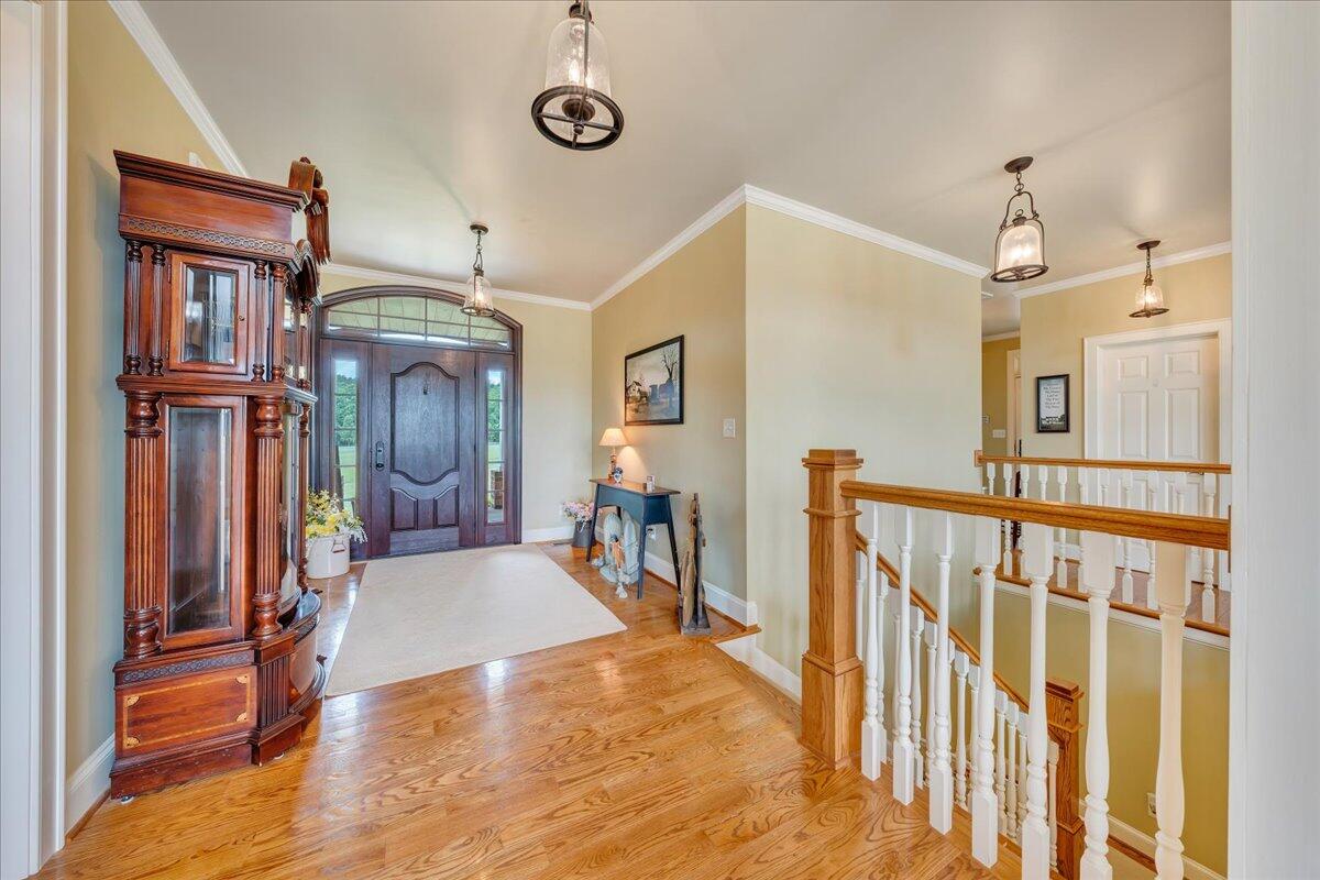 400 Quail Ridge Drive Fincastle, VA 24090 - Photo 14 of 113 a view of a hallway with a dining table chairs and chandelier