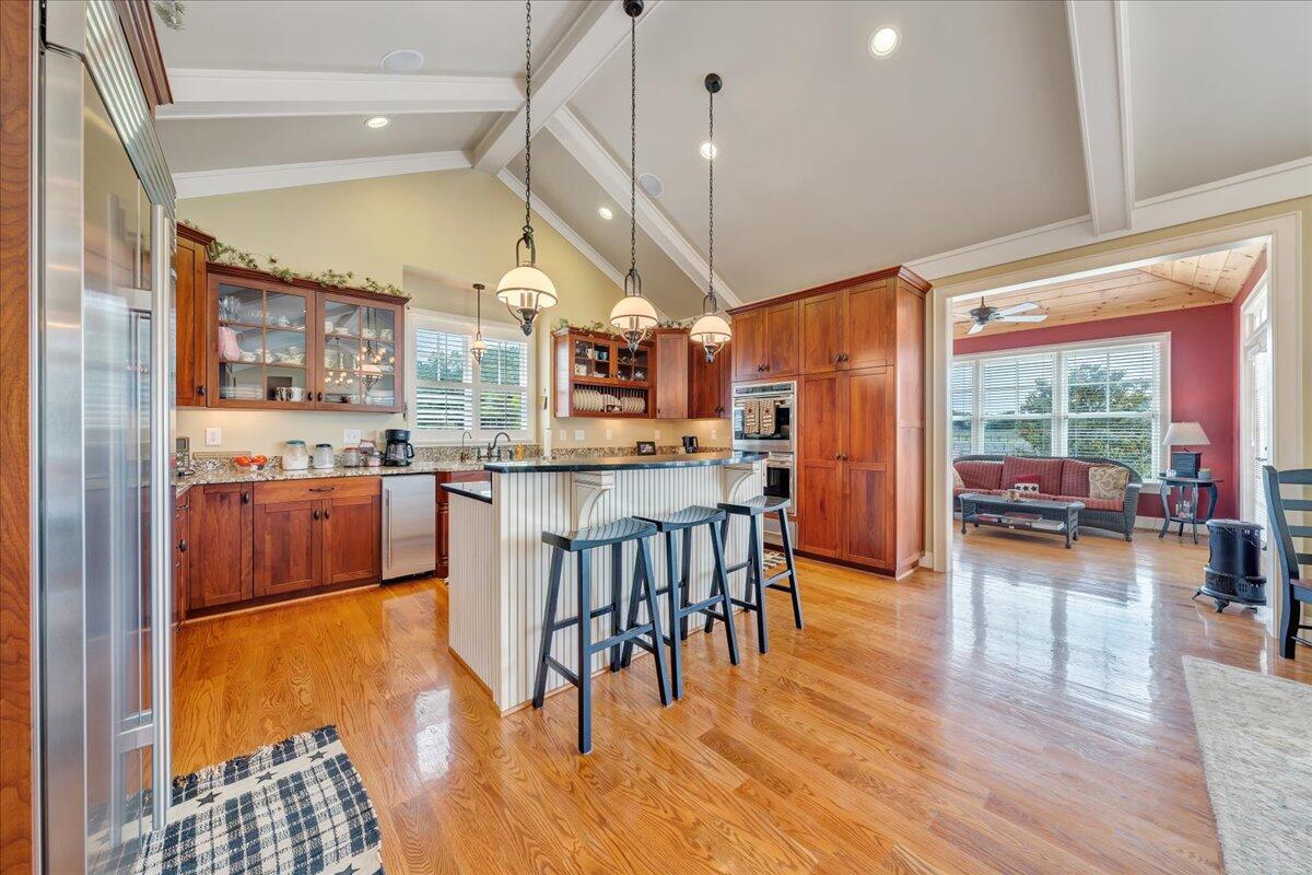 400 Quail Ridge Drive Fincastle, VA 24090 - Photo 23 of 113 a open kitchen with stainless steel appliances granite countertop a stove top oven a dining table and chairs with wooden floor