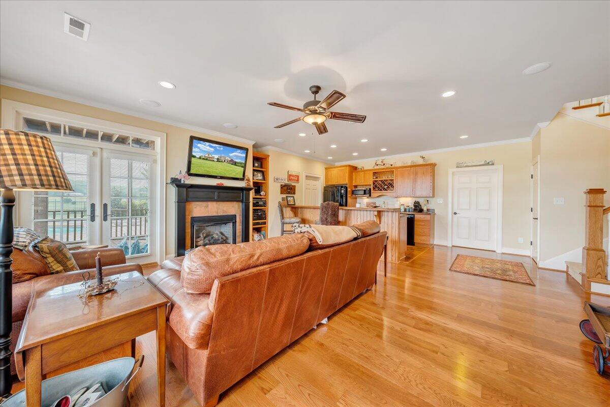 400 Quail Ridge Drive Fincastle, VA 24090 - Photo 48 of 113 a living room with furniture a fireplace and a flat screen tv