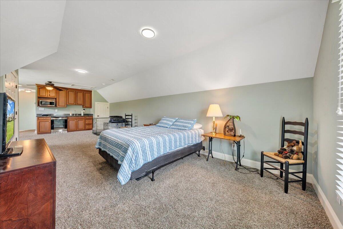 400 Quail Ridge Drive Fincastle, VA 24090 - Photo 65 of 113 a bedroom with a bed and a chandelier