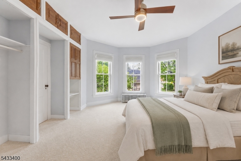 61 New Street Hampton, NJ 08827 - Photo 31 of 45 a bedroom with a large bed and a chandelier