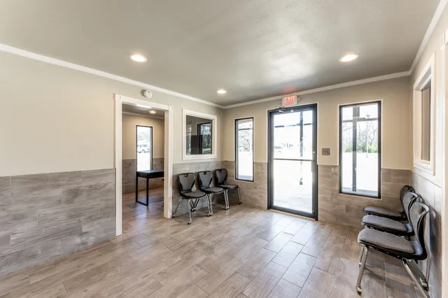 a living room with furniture and large windows