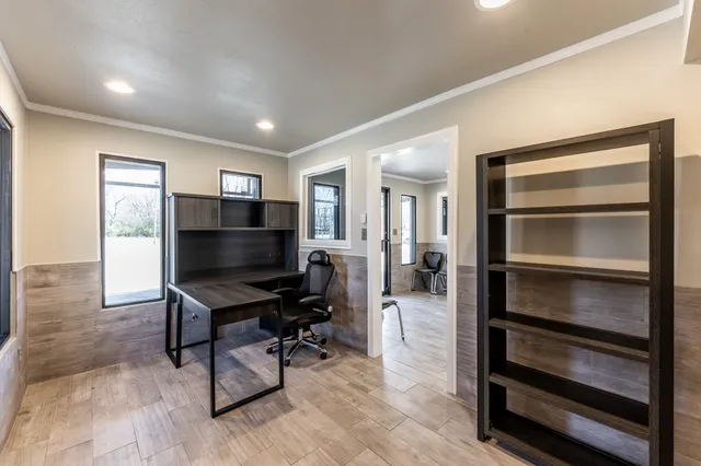 a living room with furniture a flat screen tv and piano table