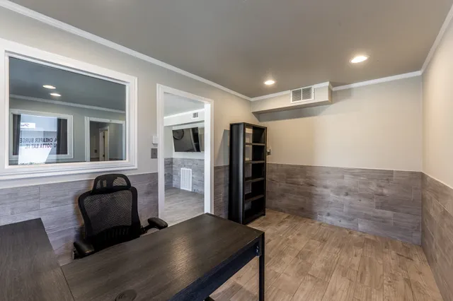 a hallway with furniture and a large window