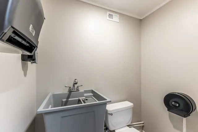 a bathroom with a toilet a sink and bathtub
