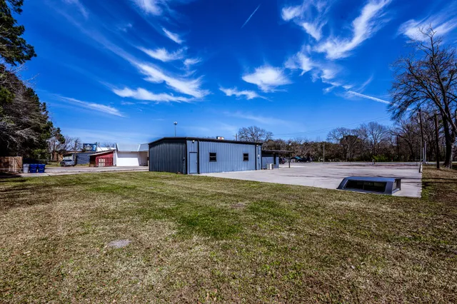 a backyard of a house with table and chairs