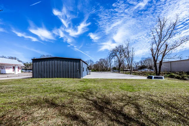 a view of a backyard with large trees