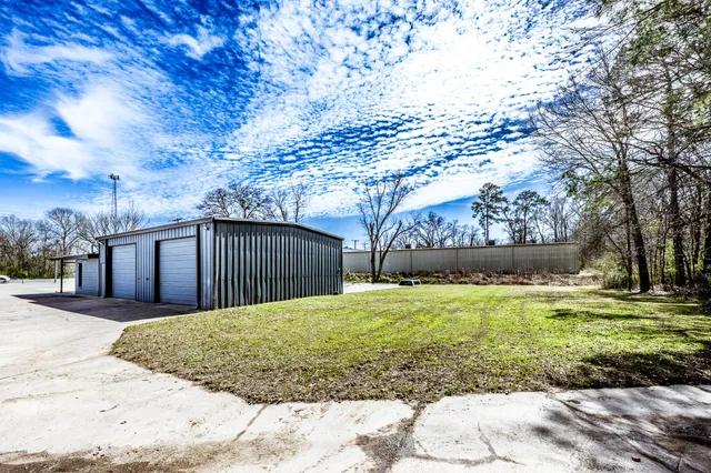 a view of a backyard with large trees