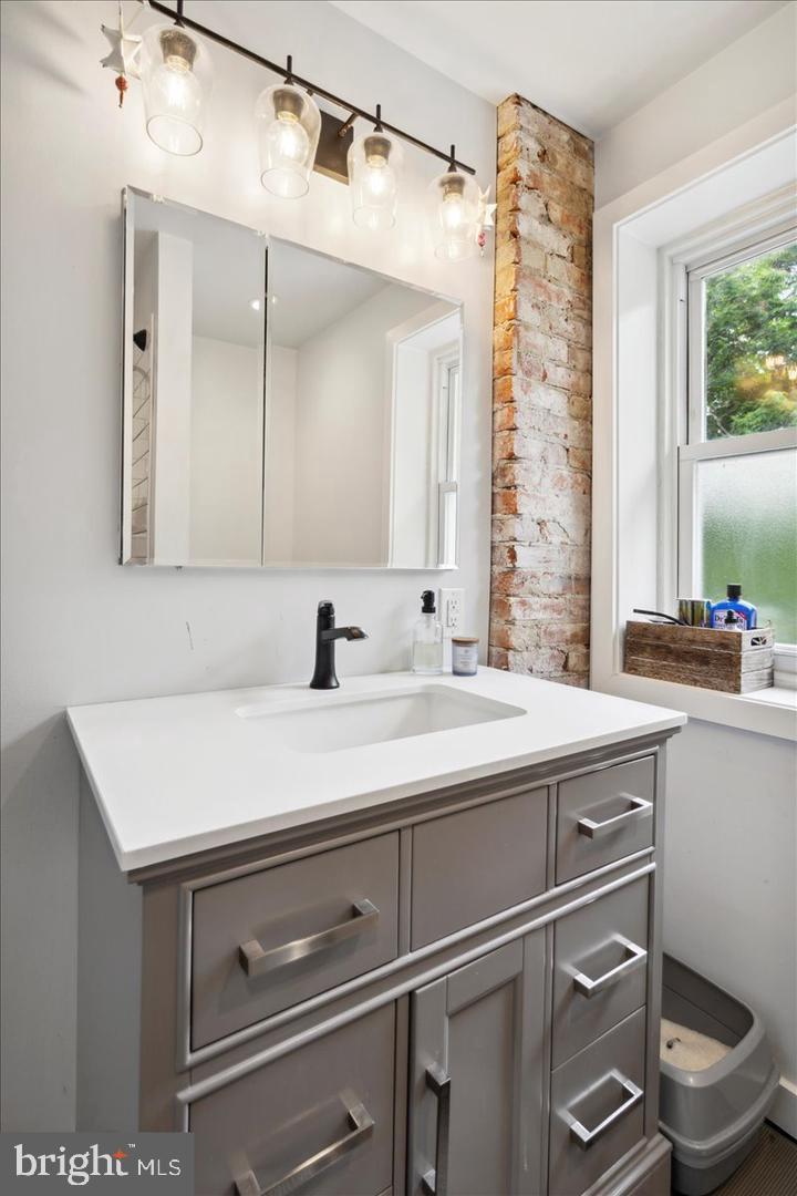 224 Edgemont Avenue Ardmore, PA 19003 - Photo 18 of 20 a sink with a toilet and a mirror