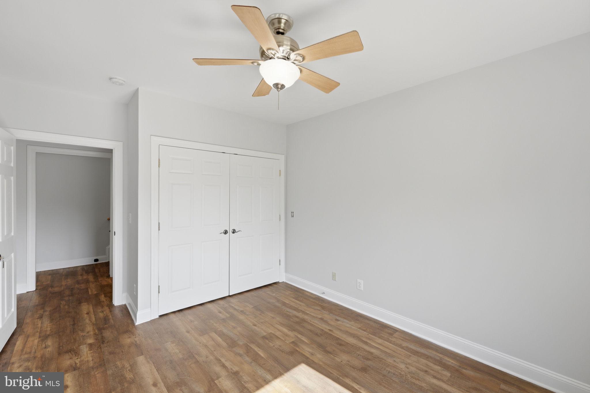 7522 Stubbs Bridge Road Spotsylvania, VA 22551 - Photo 31 of 60 an empty room with wooden floor and ceiling fan