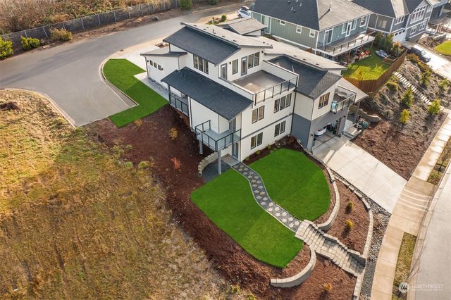 an aerial view of a house with a ocean view