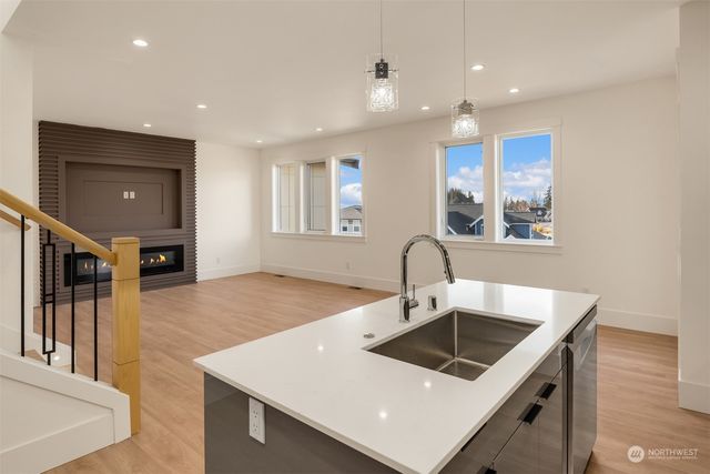 a kitchen with a sink a counter top space and cabinets