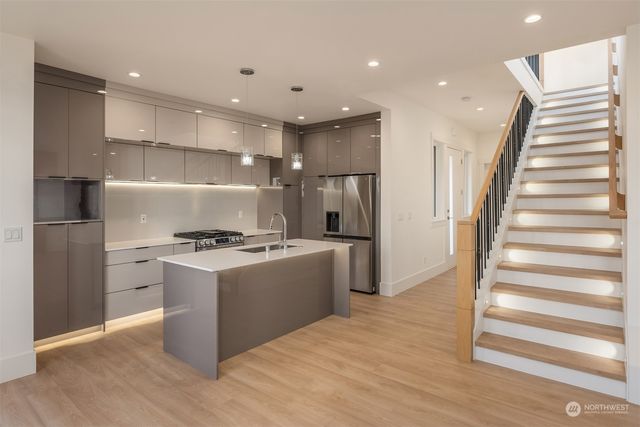 a kitchen with stainless steel appliances granite countertop a stove and a refrigerator