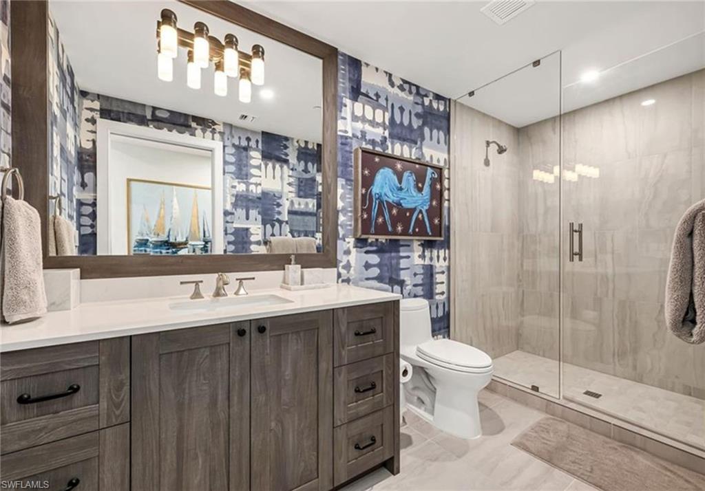 13925 Old Coast Road, Unit 2201 Naples, FL 34110 - Photo 13 of 28 a spacious bathroom with a double vanity sink toilet mirror and shower