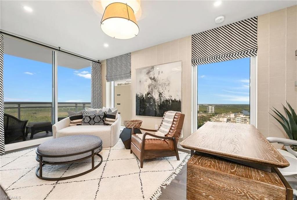 13925 Old Coast Road, Unit 2201 Naples, FL 34110 - Photo 16 of 28 a living room with furniture and a floor to ceiling window