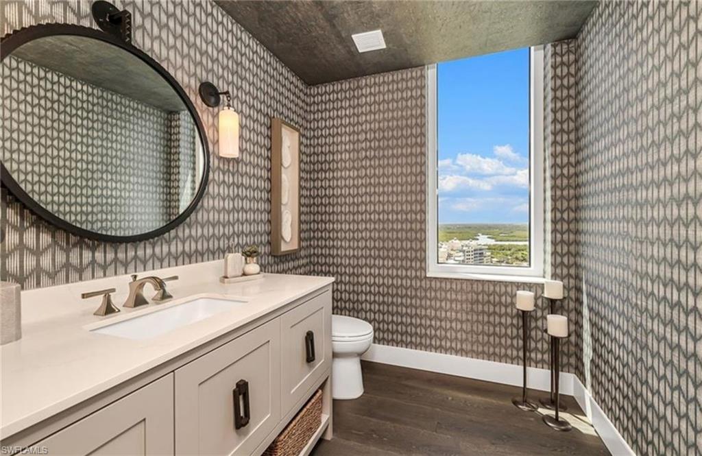 13925 Old Coast Road, Unit 2201 Naples, FL 34110 - Photo 17 of 28 a bathroom with a sink and a mirror