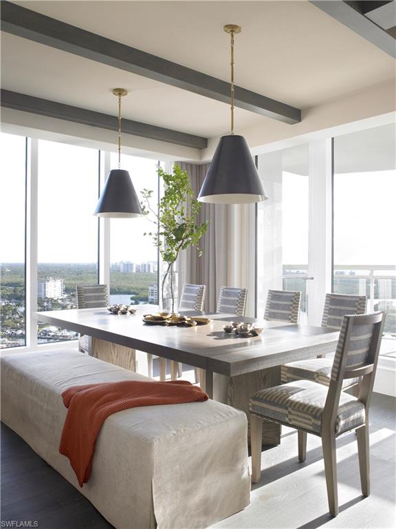 13925 Old Coast Road, Unit 2201 Naples, FL 34110 - Photo 6 of 28 a dining room with furniture a chandelier and a large window