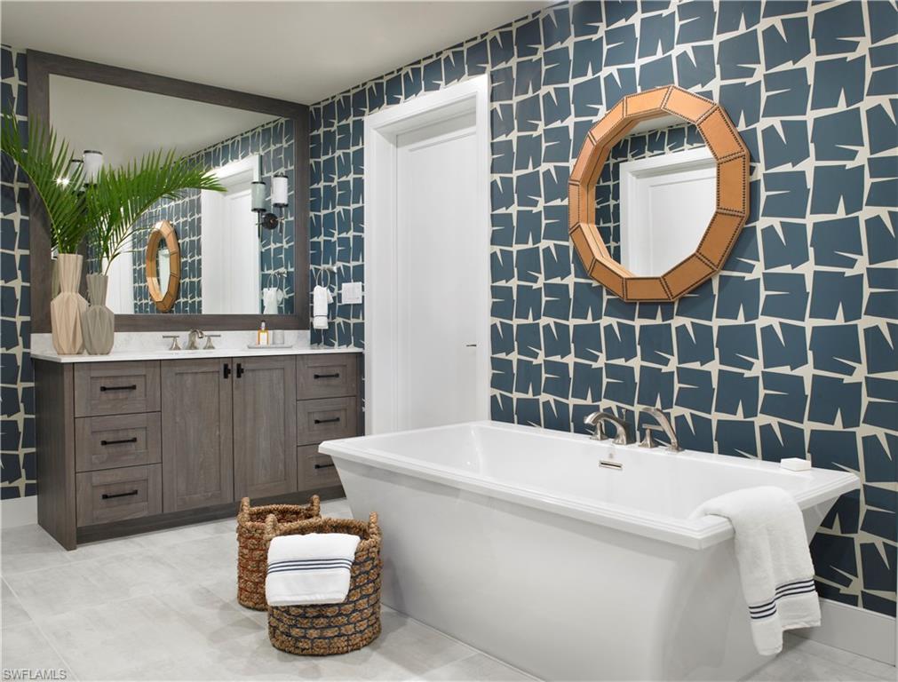 13925 Old Coast Road, Unit 2201 Naples, FL 34110 - Photo 10 of 28 a bathroom with a sink and a mirror