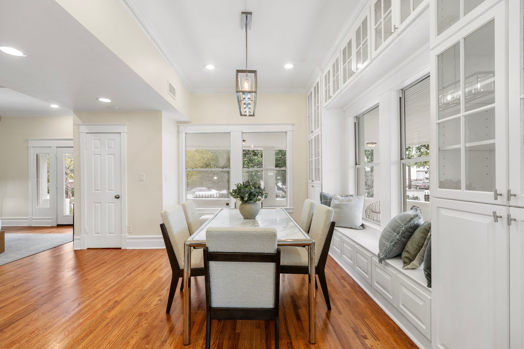 607 Harvard Street Houston, TX 77007 - Photo 13 of 50 Large windows facing south and east flood the dining room with natural light while a wall of new built-ins boasts gorgeous glass-front cabinetry and a wide window seat with storage below.
