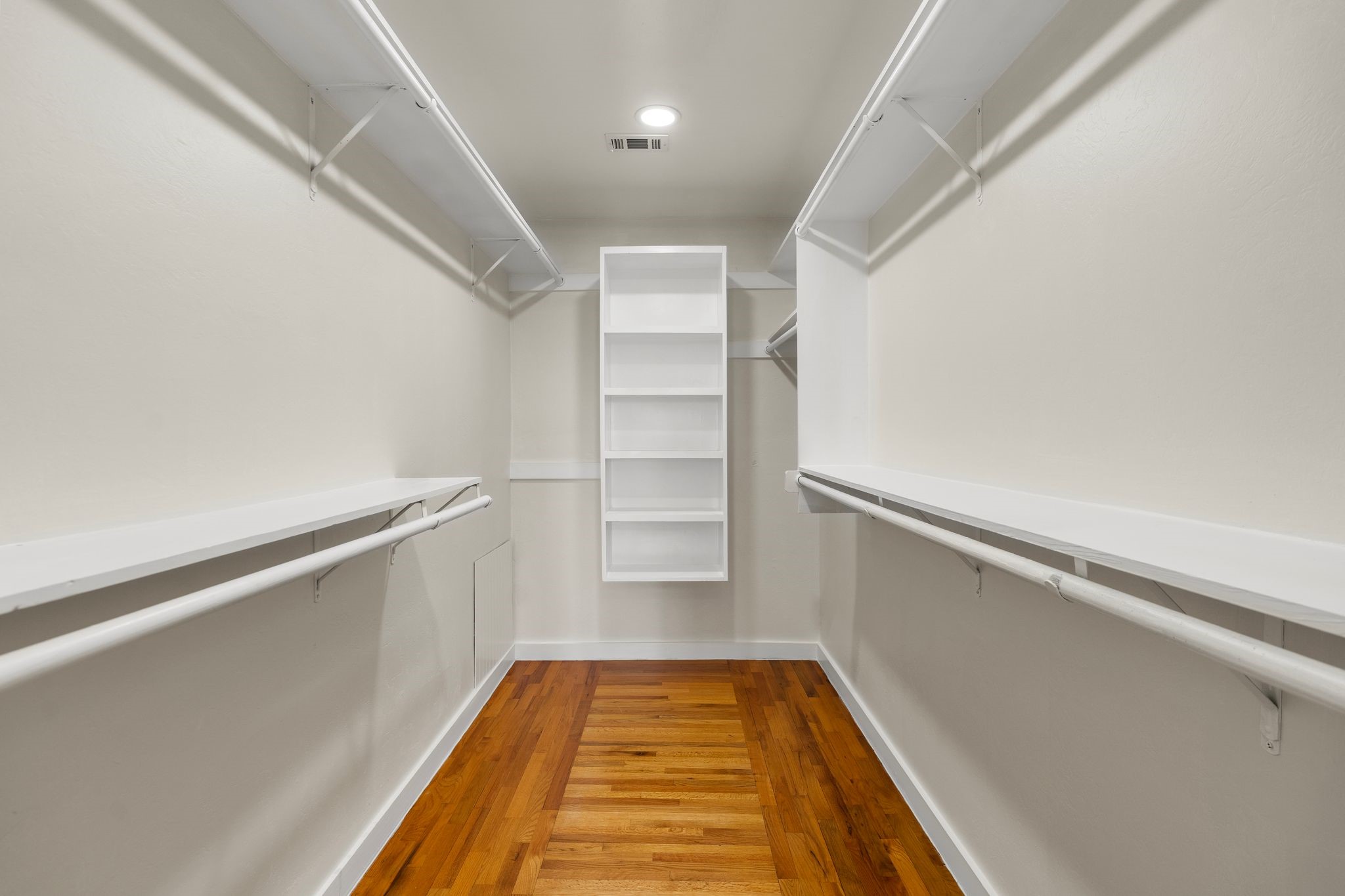 607 Harvard Street Houston, TX 77007 - Photo 23 of 50 The primary’s walk-in closet maximizes storage space with double hanging rods and shelving, while a second closet