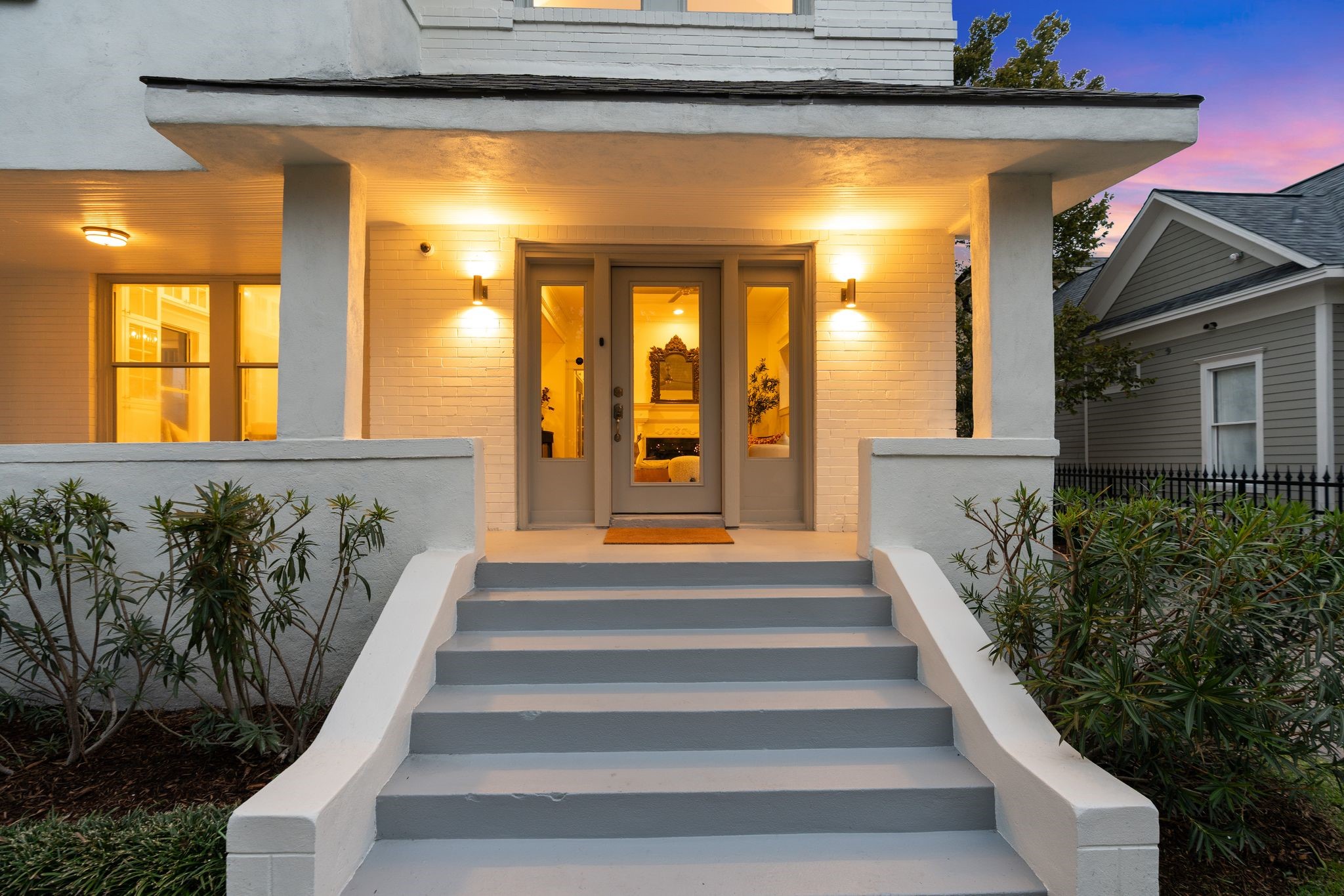 607 Harvard Street Houston, TX 77007 - Photo 7 of 50 The glass entry door is flanked by sidelights and contemporary lighting, while security cameras provide added safety.
