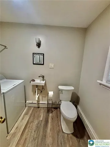 a white toilet sitting next to a bathroom sink