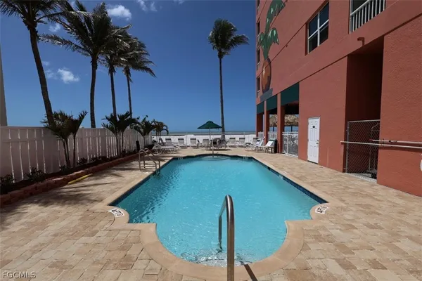 a view of swimming pool with outdoor seating and a patio