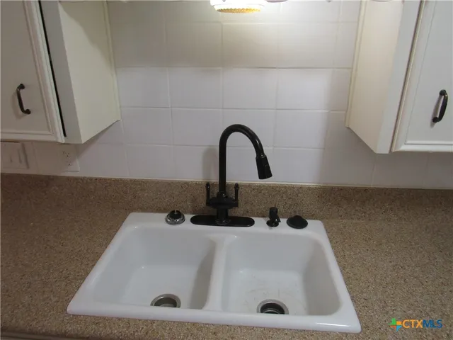 a view of a small space with wooden floor and a window