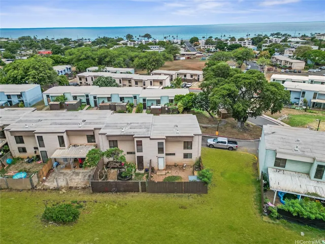 an aerial view of multiple houses with a big yard