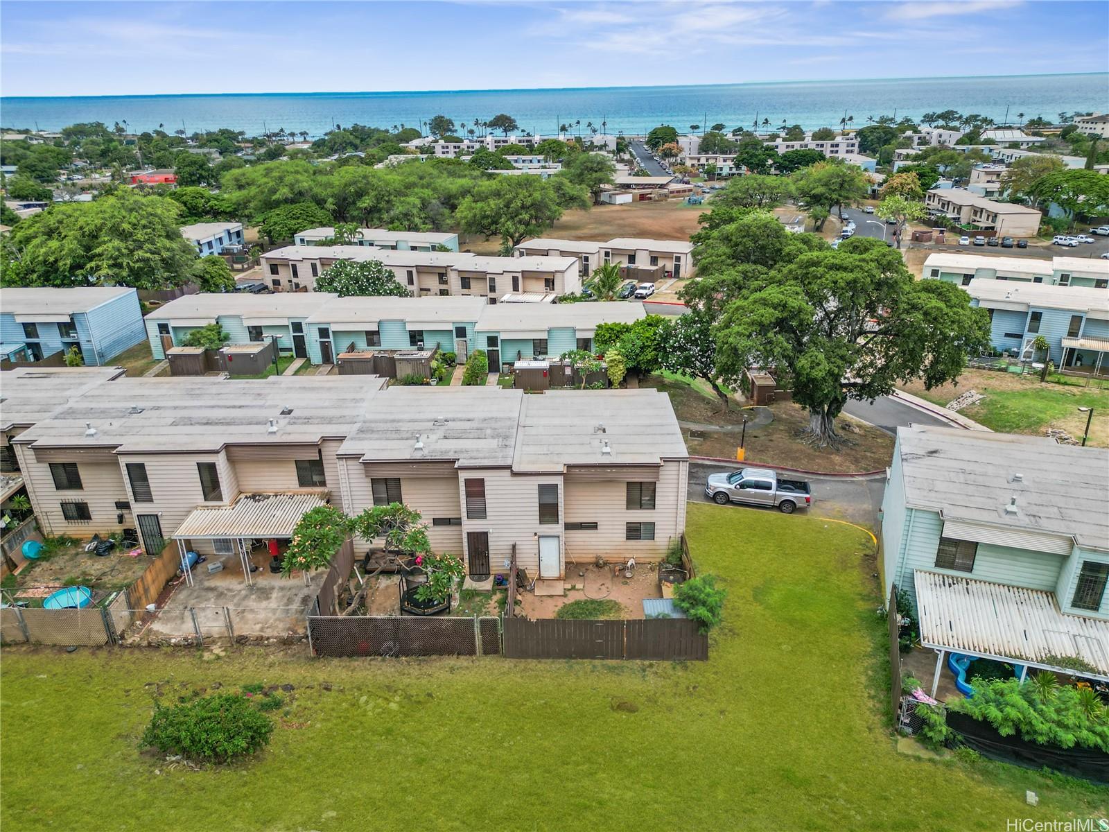 an aerial view of multiple houses with a big yard