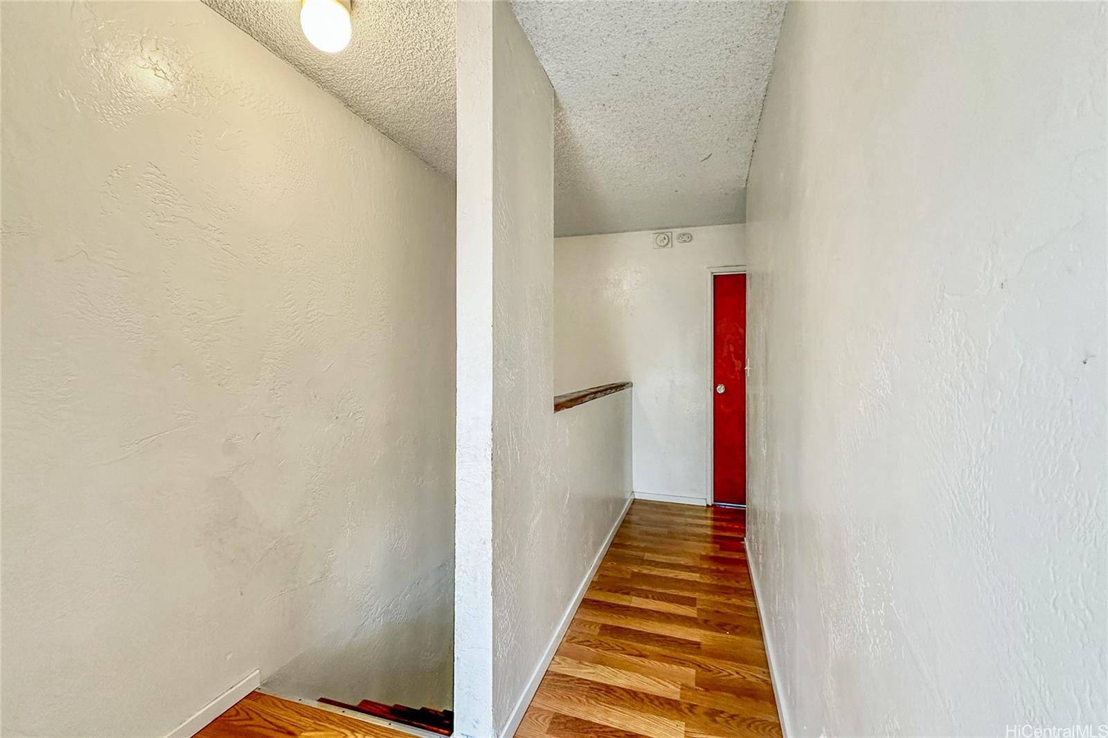 87217 Helelua Street, Unit 1 Waianae, HI 96792 - Photo 12 of 15 a view of a hallway with wooden floor and entryway