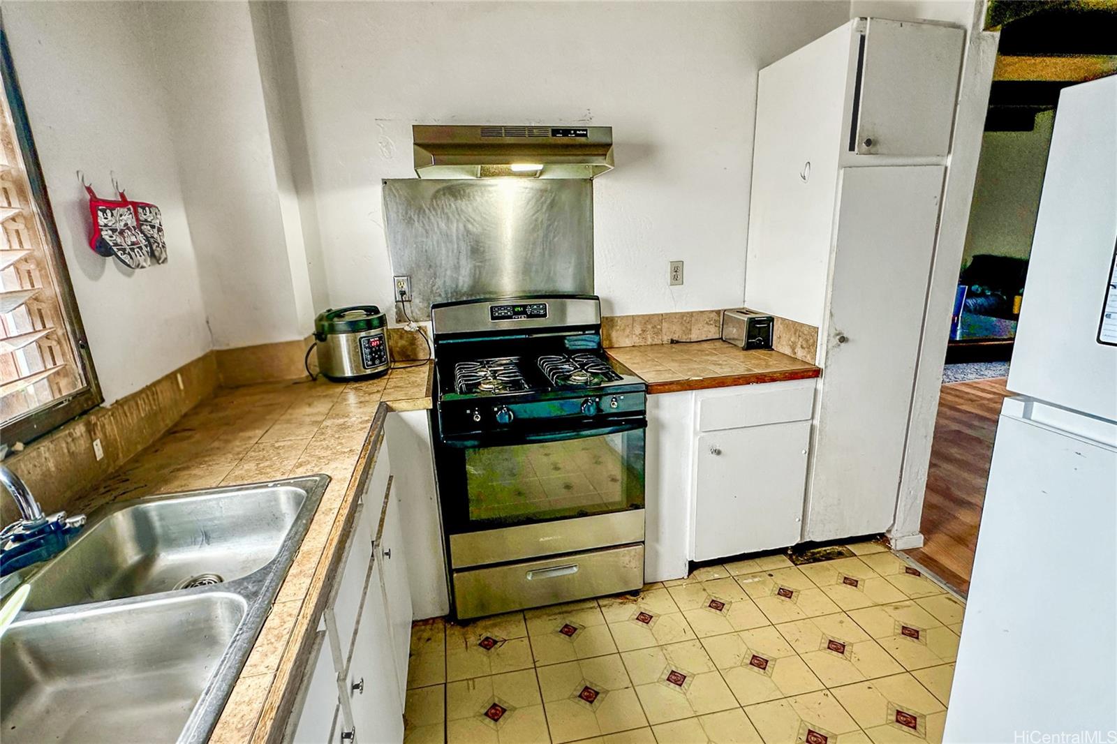 87217 Helelua Street, Unit 1 Waianae, HI 96792 - Photo 13 of 15 a kitchen with a stove and a sink