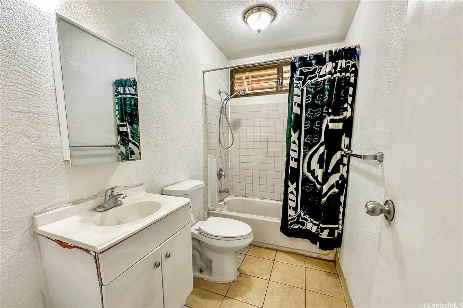 87217 Helelua Street, Unit 1 Waianae, HI 96792 - Photo 14 of 15 a bathroom with a sink toilet and shower