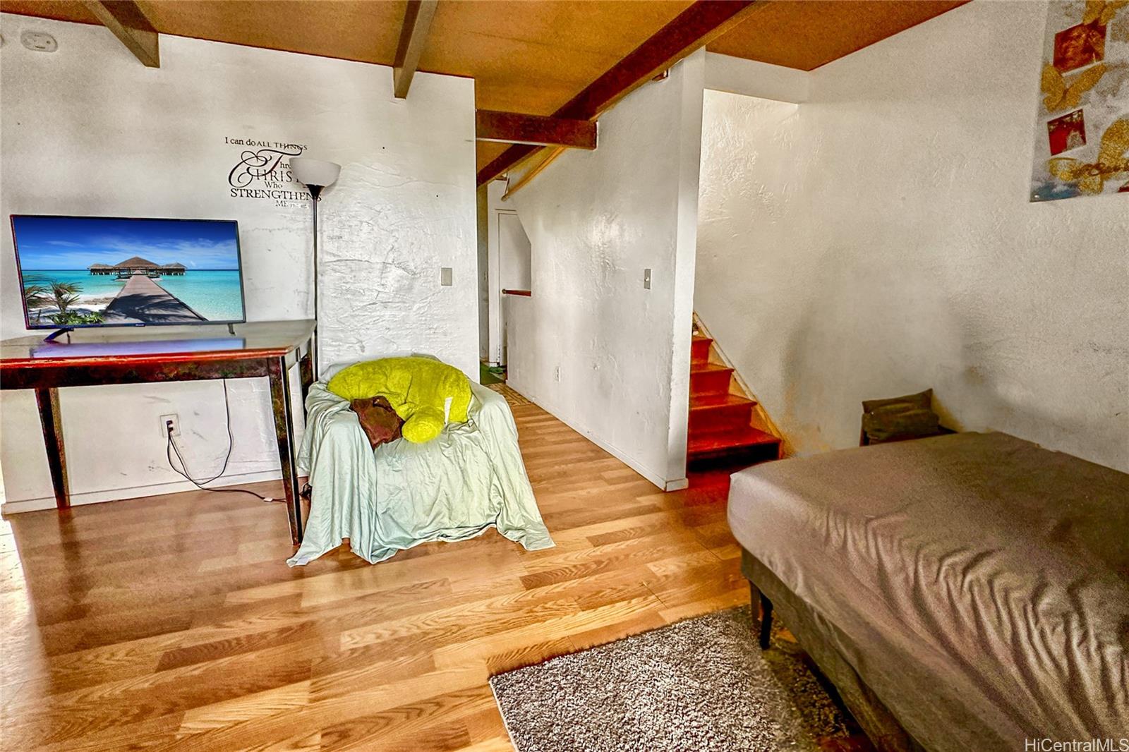 87217 Helelua Street, Unit 1 Waianae, HI 96792 - Photo 9 of 15 a bedroom with a bed and a painting on the wall