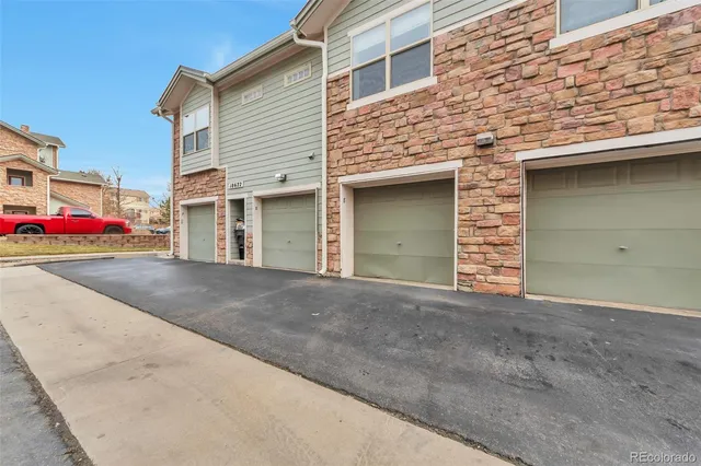 a view of a house with a yard and garage