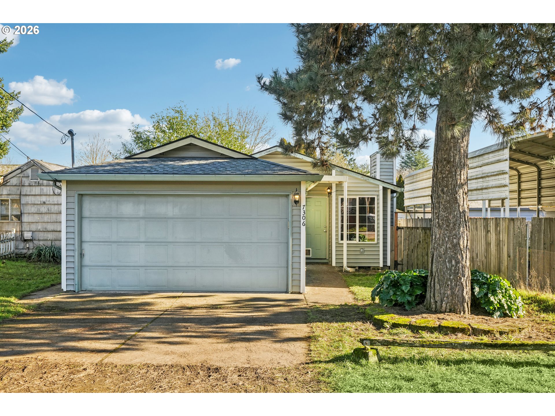 7306 Southeast 76th Avenue Portland, OR 97206 - Photo 1 of 34 a front view of a house with a yard