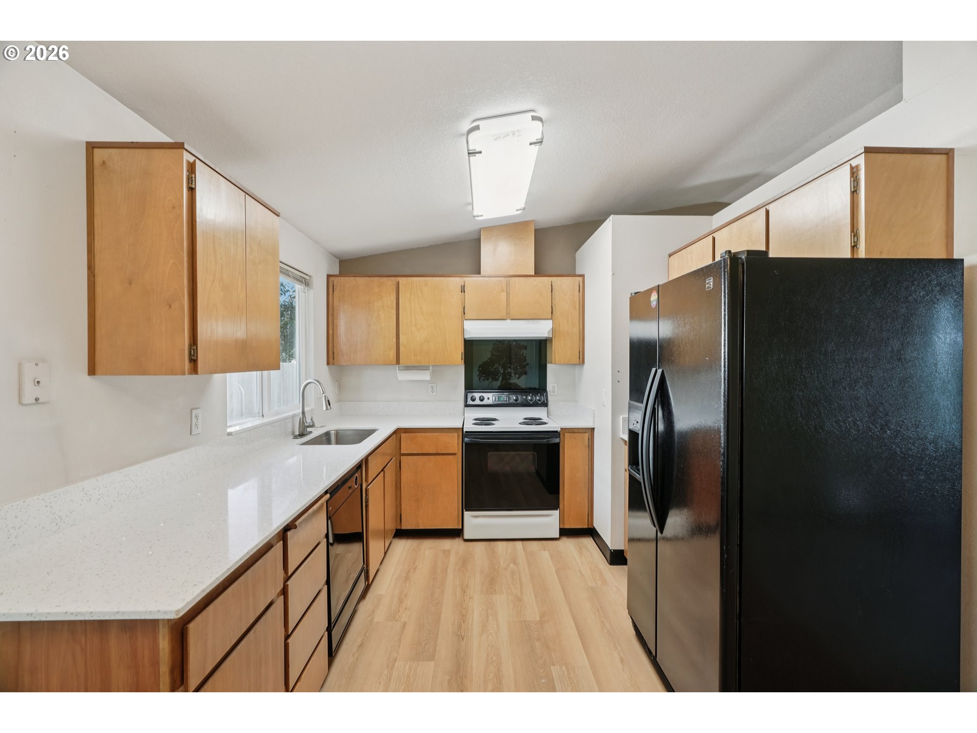 7306 Southeast 76th Avenue Portland, OR 97206 - Photo 12 of 34 a kitchen with stainless steel appliances a refrigerator sink and stove