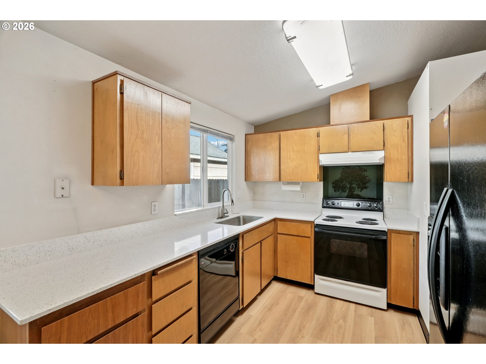 7306 Southeast 76th Avenue Portland, OR 97206 - Photo 13 of 34 a kitchen with stainless steel appliances granite countertop a sink stove and refrigerator