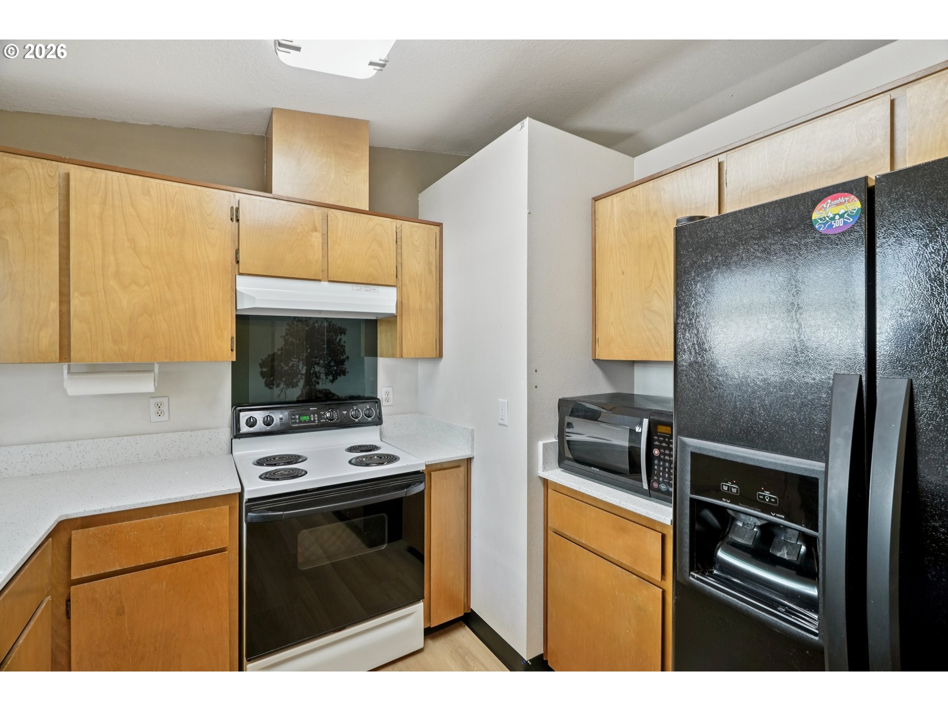 7306 Southeast 76th Avenue Portland, OR 97206 - Photo 14 of 34 a kitchen with stainless steel appliances a stove a microwave and a refrigerator